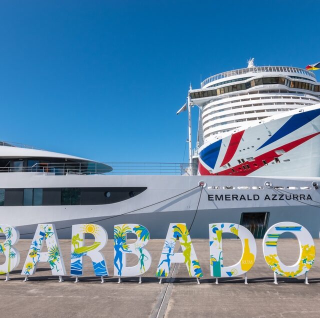 Bridgetown, Barbados - November 25, 2023: Luxury Yacht Cruise ship Emerald Azzurra and P and O Arvia cruise ship in front of Barbados sign in Port of Bridgetown.